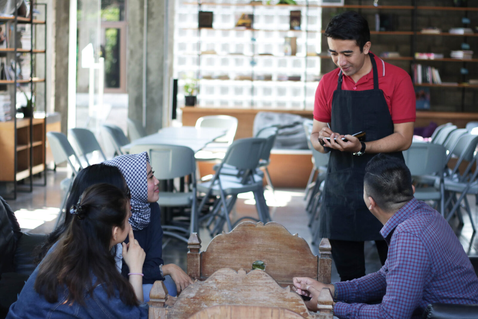 Waiting staff serving customers in a busy restaurant
