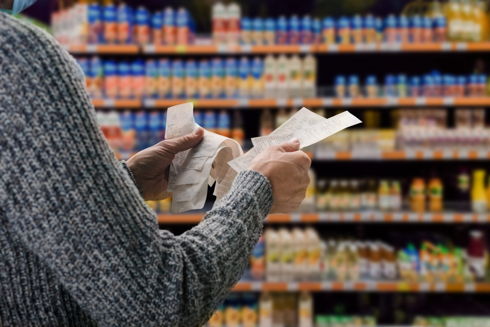 A shopper reviewing prices and receipts