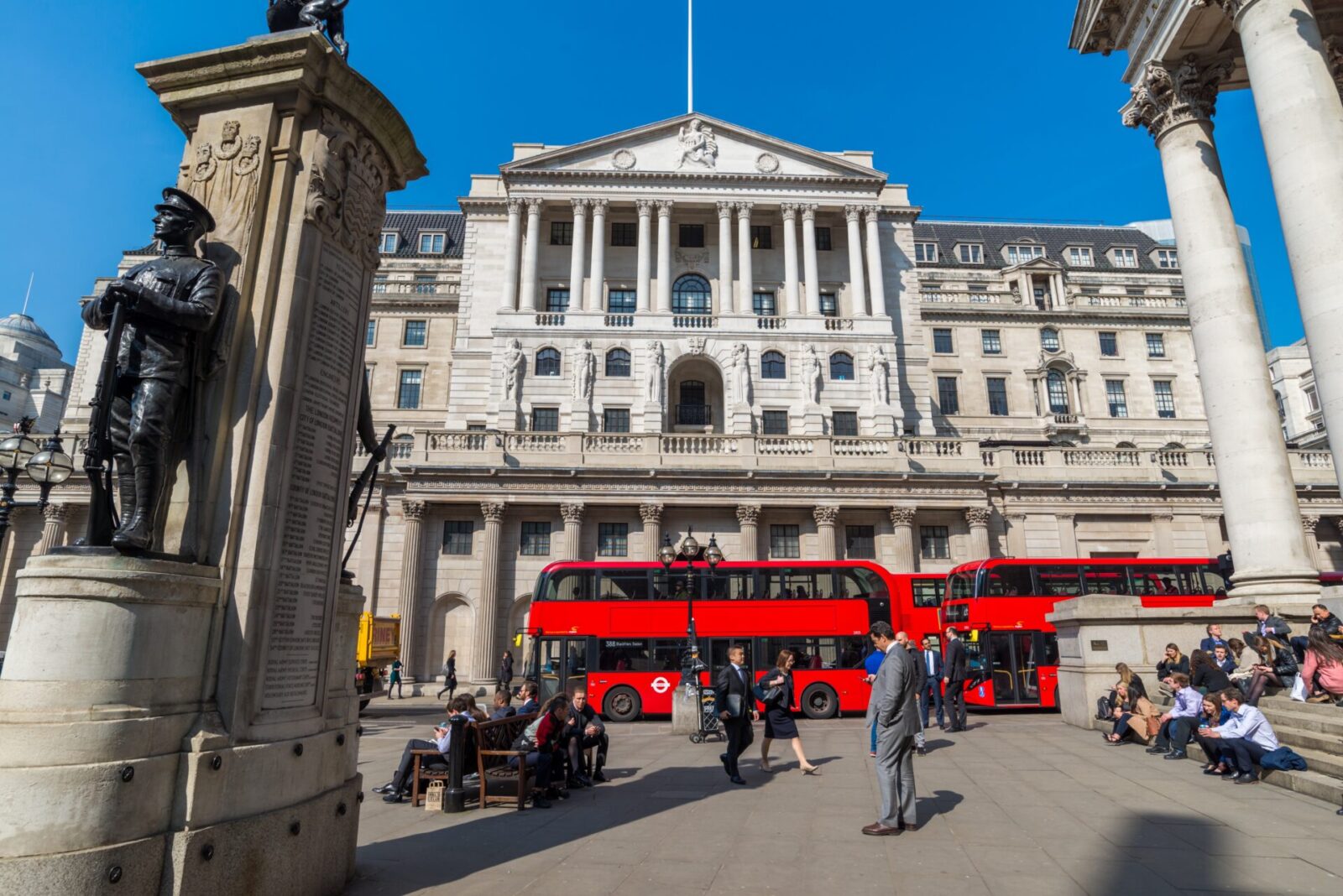 The Bank of England in the City of London as commuters walk past.