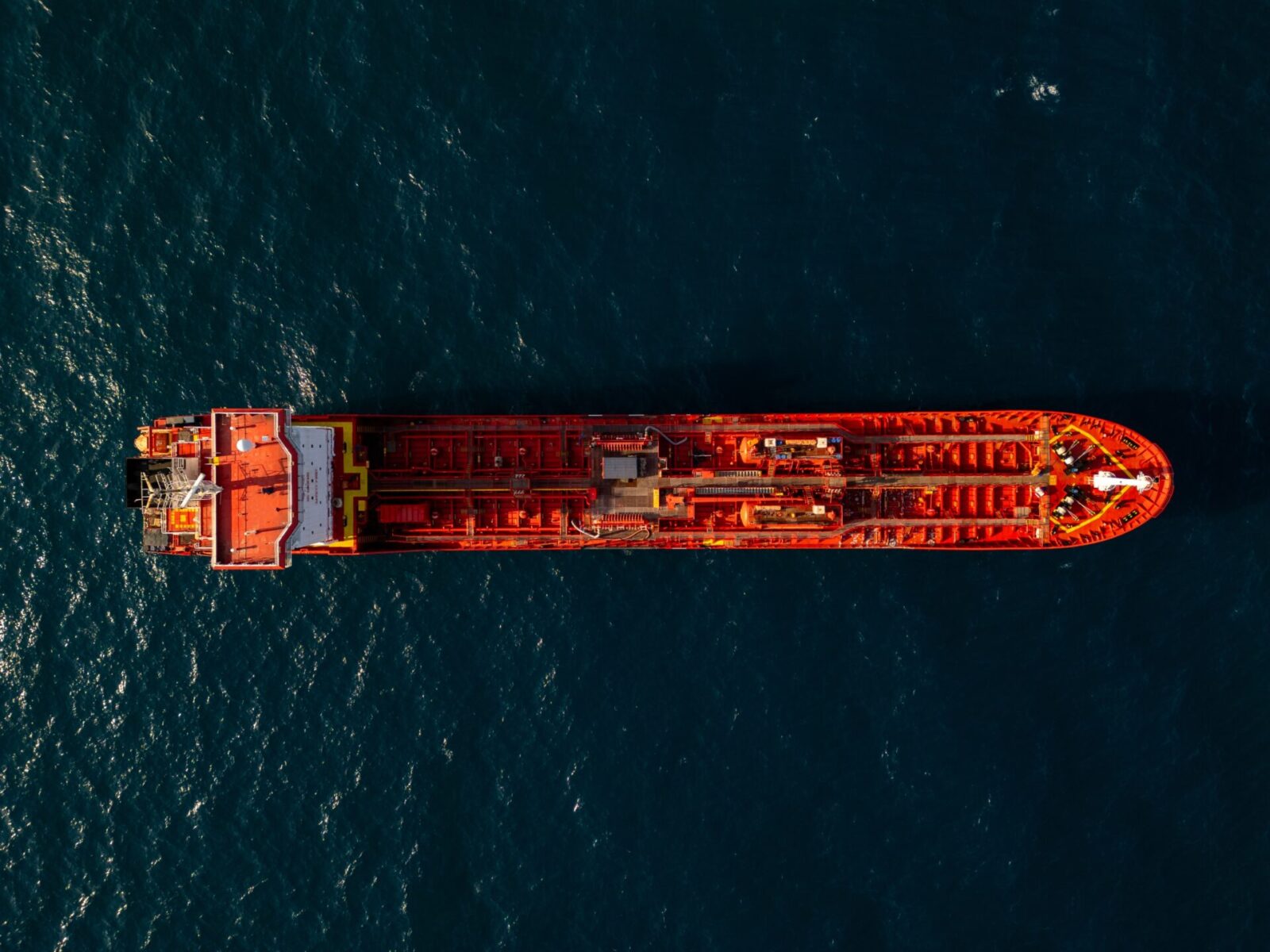 "An aerial view of a loaded crude oil tanker at sea, reflecting disruption to Gulf shipping and rising oil prices.